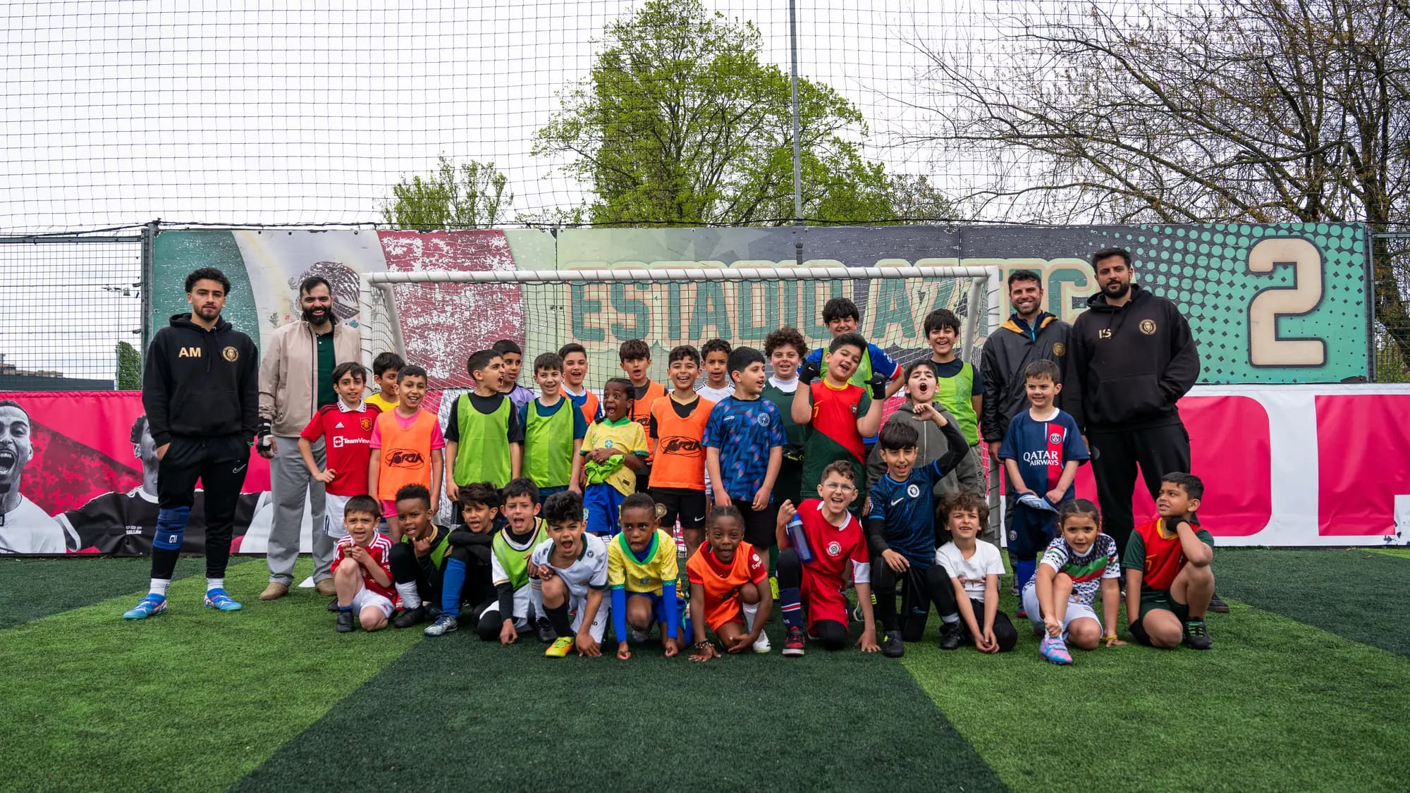 YKQ Sports coaches training with young players — boys and girls